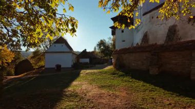 Viscri fortified church and the surrounding village and countryside, Transylvania, Romania, unites a hilltop church, enclosing walls, cobbled lanes, and open fields