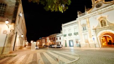 FARO, Portugal, 15 January 2025 - Arco da Vila Arch, Faro, The Algarve, Portugal by night, frames the city gate with layered stonework, a niche statue, and a bell tower above