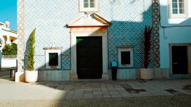 Chapel of Saint Lazarus or Our Lady of Deliverance, Tavira, The Algarve, Portugal, appears as a modest church with white walls, a simple portal, and a small bell gable, set on a corner square