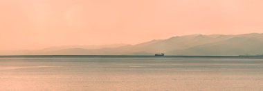 Panoramik Dağları ile gün batımında gemi