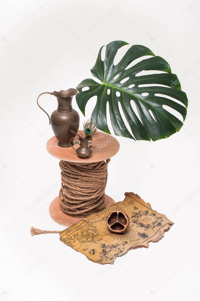 Copper potswith treasure and leaves Monstera on white background