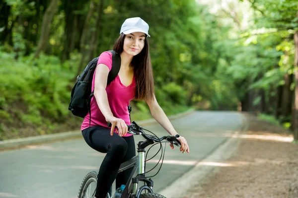 Brunette Cyclist Girl White Cap Bike Asphalt Road Forest — Stock Photo, Image