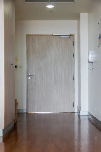 wooden door in the hospital room was closed