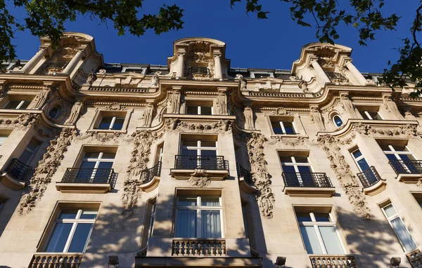 Traditional French house with typical balconies and windows. Paris, France.