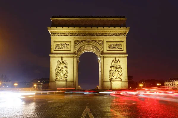 The Triumphal Arch in rainy evening. It is one of the most famous monuments in Paris. It honors those who fought and died for France.