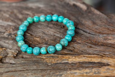 The Turquoise stone bracelet on the stump wood clipart