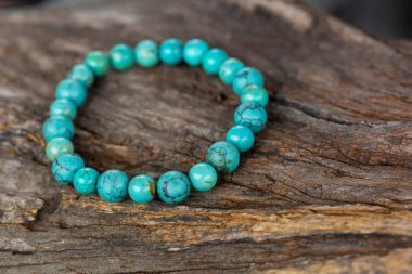 The Turquoise stone bracelet on the stump wood clipart