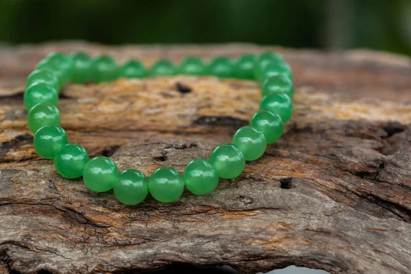 The Aventurine Stone Bracelet on the stump wood