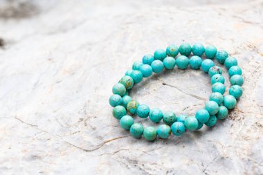 The Turquoise stone bracelet on the rock clipart