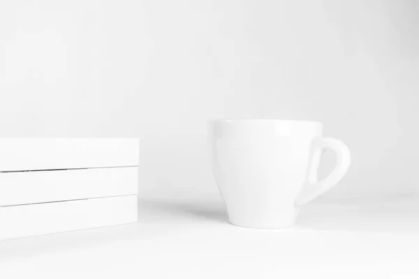 White Cup with space for logo and the white book