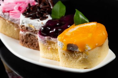 Tatlı pasta siyah arka plan üzerine beyaz çanak üzerinde