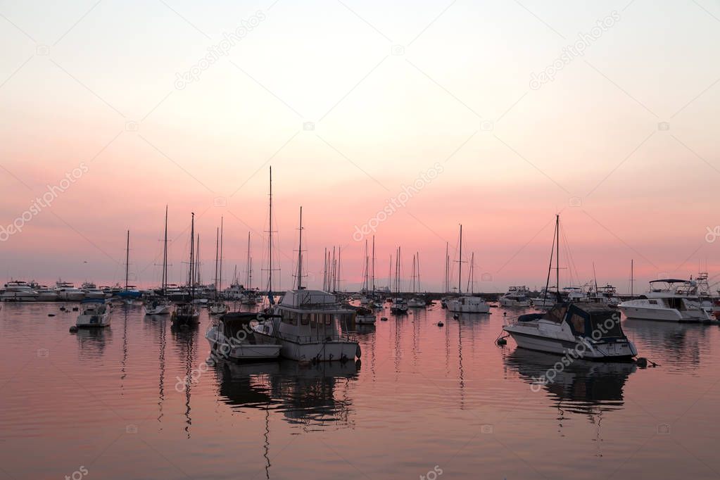 Boats silhouttes in pink sunset