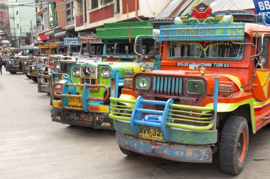 Baguio, Philippines - June 3, 2016: Jeepney station with colourful jeepneys lined up clipart