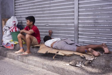 Homeless filipino boys on the streets clipart