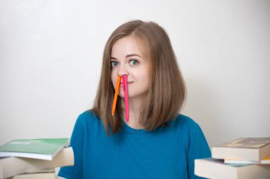 Bir sürü kitabı olan, üniversitede ya da okulda okuyan, gülümseyen beyaz bir kız.