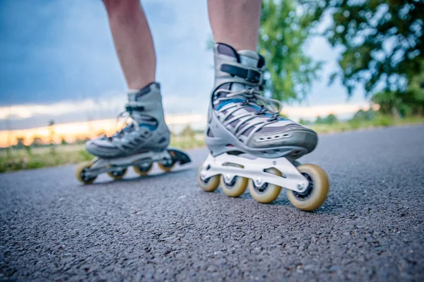 roller skates in action on the asphalt trail at freestyle races outside the city