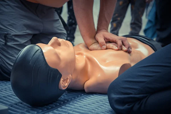 first aid training with dummy, heart massage