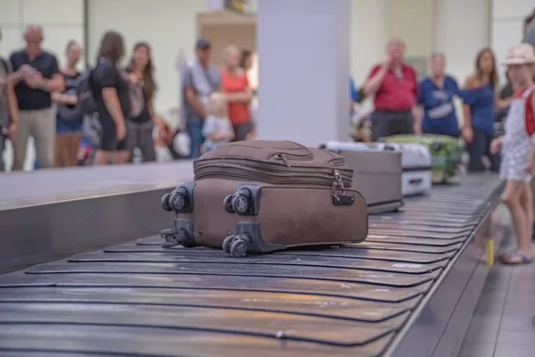 乗客は空港ロビーのパスポートで荷物を待っています. — ストック写真