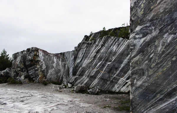 gray natural marble with white streaks in the canyon, deposit, Karelia