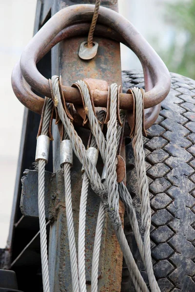 Hydraulic system. The device metal rings attached with steel cables to the yellow loader and spare rubber tire on the side. reporting shooting