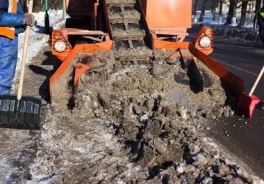 Kar, yoldaki kirli karı hasat eder. Gatchina, Rusya. Kar temizleme, haber çekimi