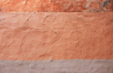 turuncu duvar dokusu. farklı tonlarla boyanmış alçı.