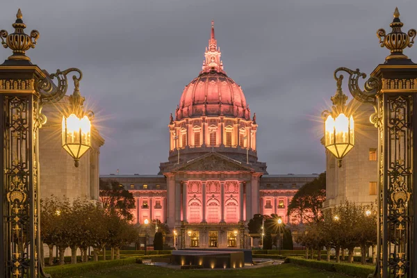 San Francisco City Hall illuminated in Amber in Thanksgiving Eve. Shot from outside the War Memorial Courtyard, San Francisco, California, USA.