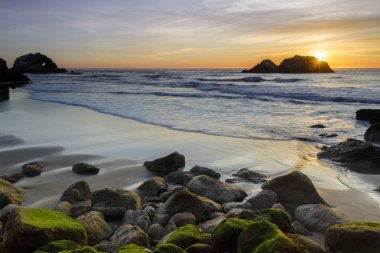 Pacific Ocean Beach Sunset with Seal Rocks viewed from the Sutro Baths. San Francisco, California, USA. clipart