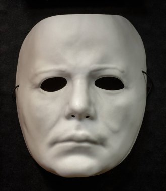 Mountain View, California - September 27, 2020: Michael Meyers Face Mask Halloween Costume Isolated Against Black Background. clipart