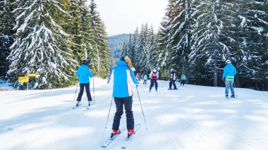 bir karlı yolda birkaç kayakçı. Dağlarda kış tatili. Dağ kayak beldesinde Karpatlar