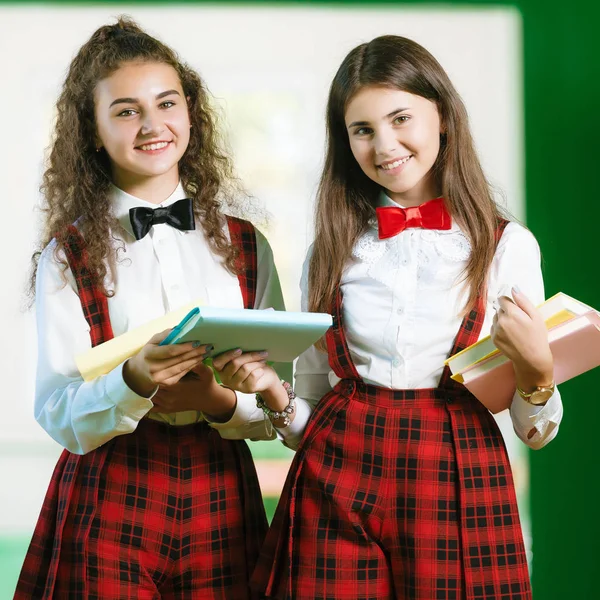 Due Studentesse Uniforme Rossa Sono Piedi Nel Corridoio Con Libri — Foto Stock