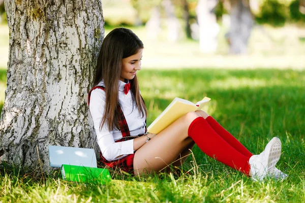 Mooie Europese Schoolmeisje Zit Een Park Buurt Van Een Boom — Stockfoto