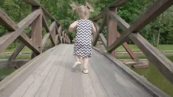 Küçük Bir Bebek Kız Ahşap Bir Köprü Boyunca Çalışan Gün — Stok video