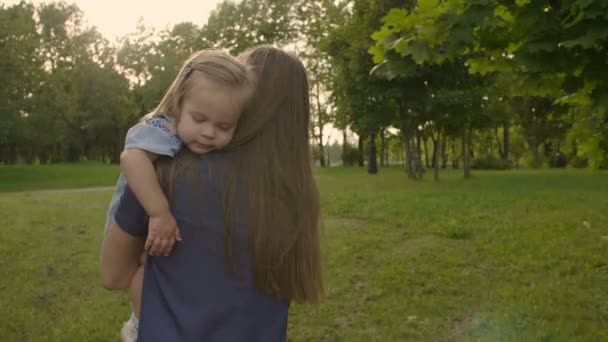 Jonge Moeder Draagt Een Vermoeide Baby Buiten Zonsondergang Zonlicht Kalmerende — Stockvideo