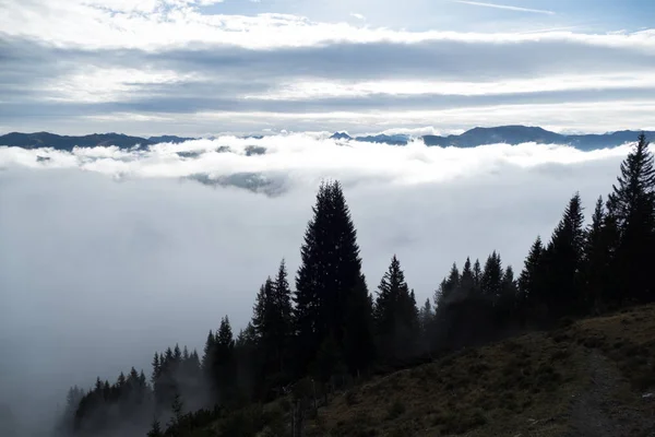 beautiful autumn hiking in berchtesgadener alps with fog in the valey and stunning views