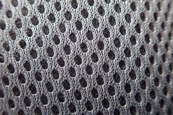Textur eines grauen Gewebes mit Löchern — Stockfoto