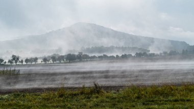 central bohemian ceske stredohori hichlands in autumn morning fog clipart
