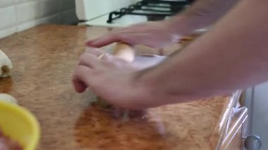 Man rolls out dough at home in the kitchen.Healthy eating concept. Homemade food.