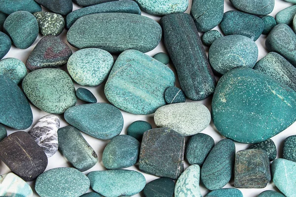 turquoise background of sea stones and pebbles.