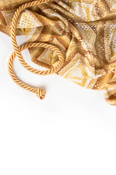 gold rope and silk on a white background.