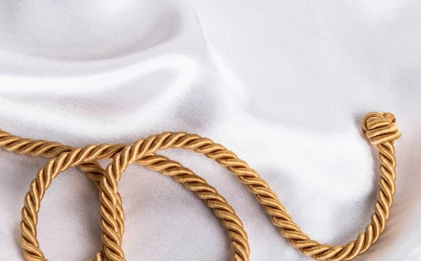 Golden Rope Knot White Silk Background Royalty Free Stock Images