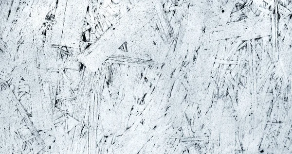Grunge texture of oriented strand board, OSB. White background from pressed wooden panel. Painted rough backdrop from wood sawdust. — Stock Image Grunge Texture Oriented Strand Board Osb White Background Pressed Wooden Stock Picture