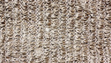 Örme bez doku. Bej kumaş örgü modeli, kaba. Kahverengi zemin ışık, yakın çekim.