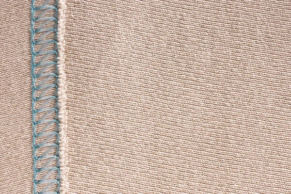 Порожня легка в'язана тканина з декоративними елементами, в'язана текстура зі зшиванням . — стокове фото