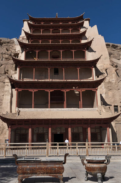 Dunhuang, China - August 8, 2012: Tourists at the entrance of the Mogao Caves near the city of Dunhuang, in the Gansu Province, China.