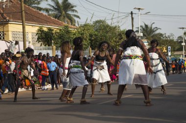 Bissau, Republic of Guinea-Bissau - February 12, 2018: Group of women wearing traditional clothing performing during the Carnival Celebrations in the city of Bisssau. clipart