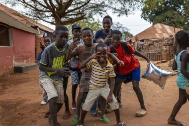 Bissau, Republic of Guinea-Bissau - February 6, 2018: Group of children playing at the Missira neighborhood in the city of Bissau, Guinea Bissau clipart