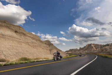 Badlands Ulusal Parkı, Güney Dakota - 9 Ağustos 2014: Badlands Ulusal Parkı 'ndaki toprak yolda motosiklet süren motorcular.