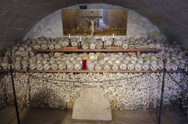 Skulls painted with names, colorful flowers and crosses in Charnel House or Beinhaus, Hallstatt, Austria. clipart