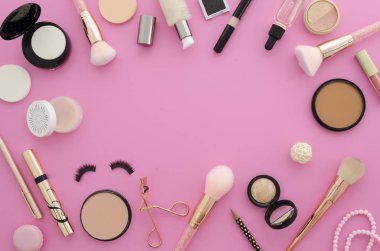 Flat lay mockup cosmetics. Make up products frame on a pink background clipart